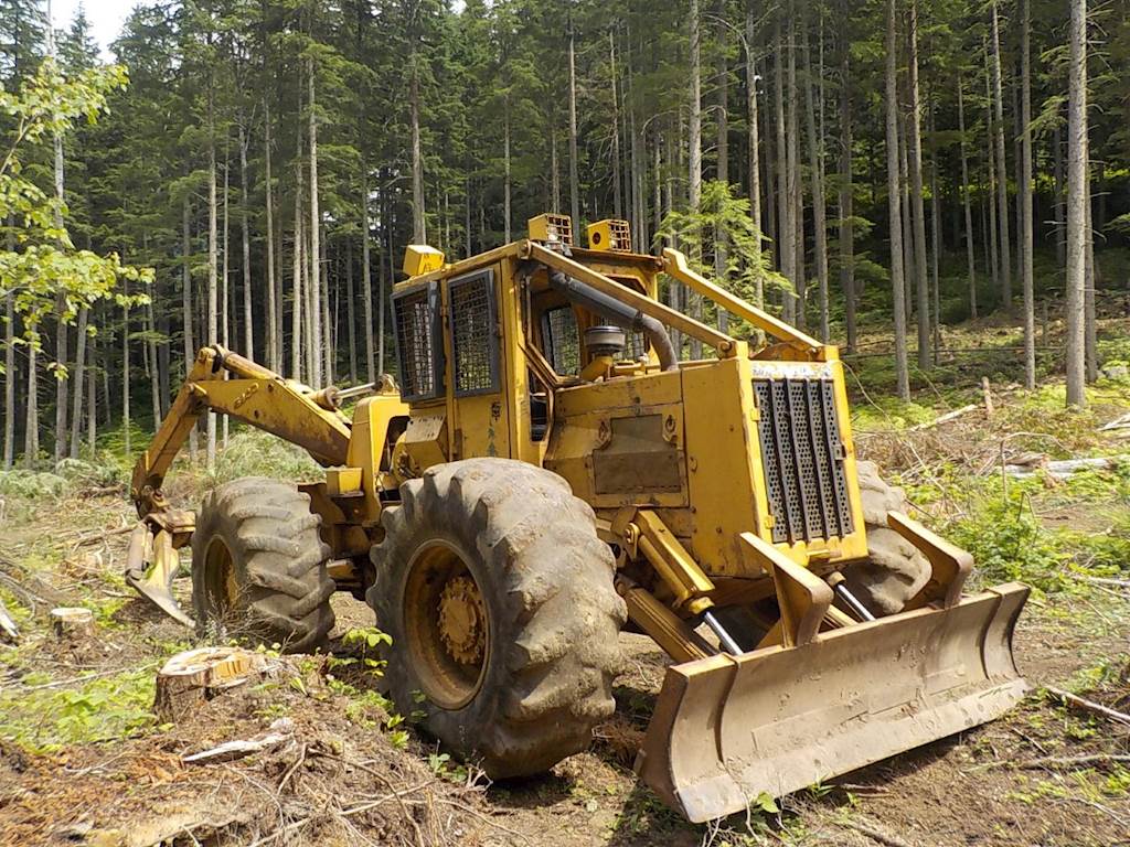 A skidder in a forest during logging operations