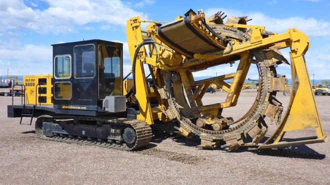 Trencher creating a trench in the soil